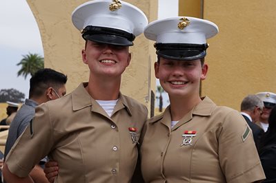 Smiling female Marine graduates